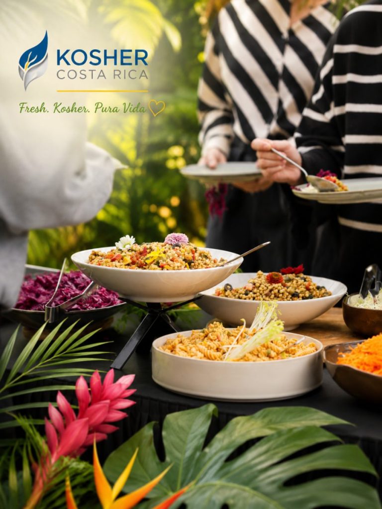 A buffet table with bowls of salads and pasta is displayed beneath a Kosher Costa Rica logo as people serve themselves.